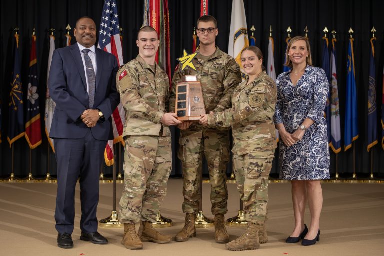 Dr. Eric Moore, Deputy to the Commanding General of U.S. Army Combat Capabilities Development Command, or DEVCOM, far left, and Beth Ferry, Director of DEVCOM Command, Control, Communications, Computers, Cyber, Intelligence Surveillance, Reconnaissance Center, far right, pose for a photo with Team Flying Wheels, comprised of students from The Citadel, as part of the DEVCOM Science, Technology, And Research, or STAR, Challenge STEM competition April 14, 2025, at Aberdeen Proving Ground, Maryland. The team won the science, technology, engineering and math competition. (U.S. Army photo by Greg Newswanger, DEVCOM Public Affairs)