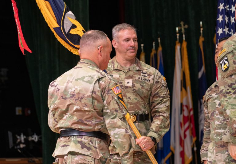 Brig. Gen. Robert Born receives the DEVCOM guidon from Lt. Gen. Miles Brown.